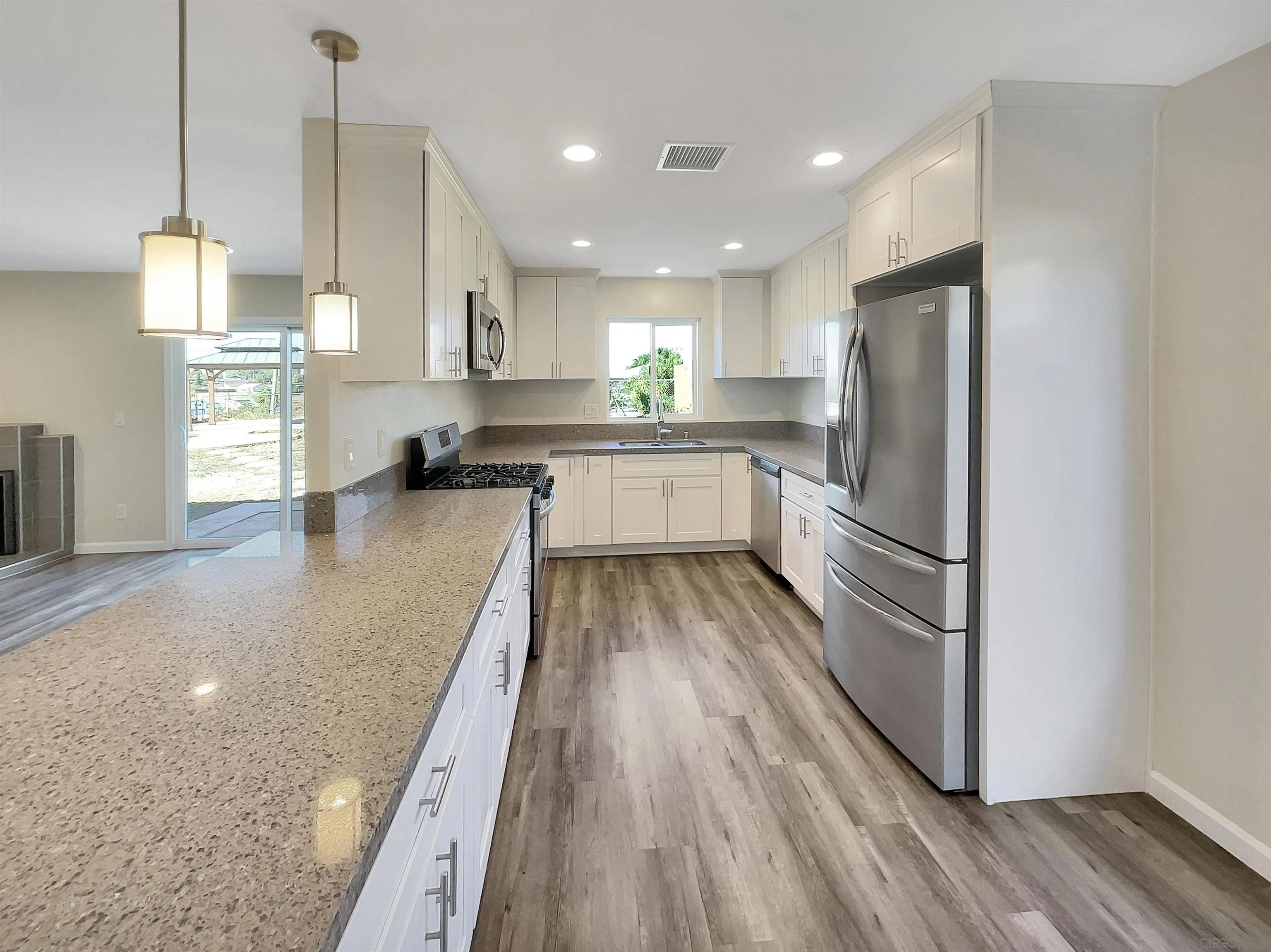 8238 Cacus Street Spring Valley, CA 91977 - Photo 6 of 22 a kitchen with a refrigerator a sink and wooden floor