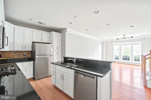 a kitchen that has a sink and a stove in it