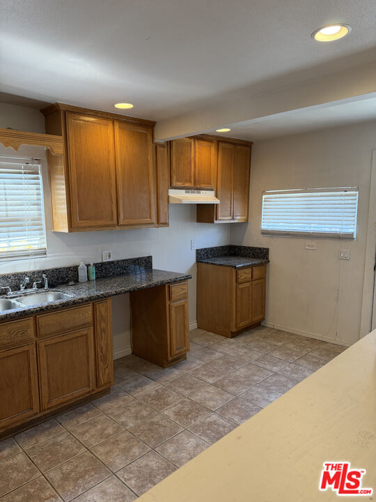 205 West Poplar Street Compton, CA 90220 - Photo 20 of 21 a kitchen with granite countertop a sink and cabinets