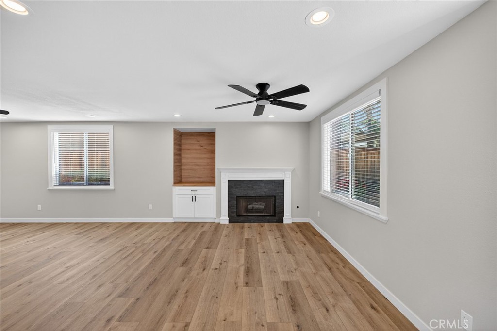 44797 Corte Sanchez Temecula, CA 92592 - Photo 12 of 58 a view of empty room with wooden floor and fireplace