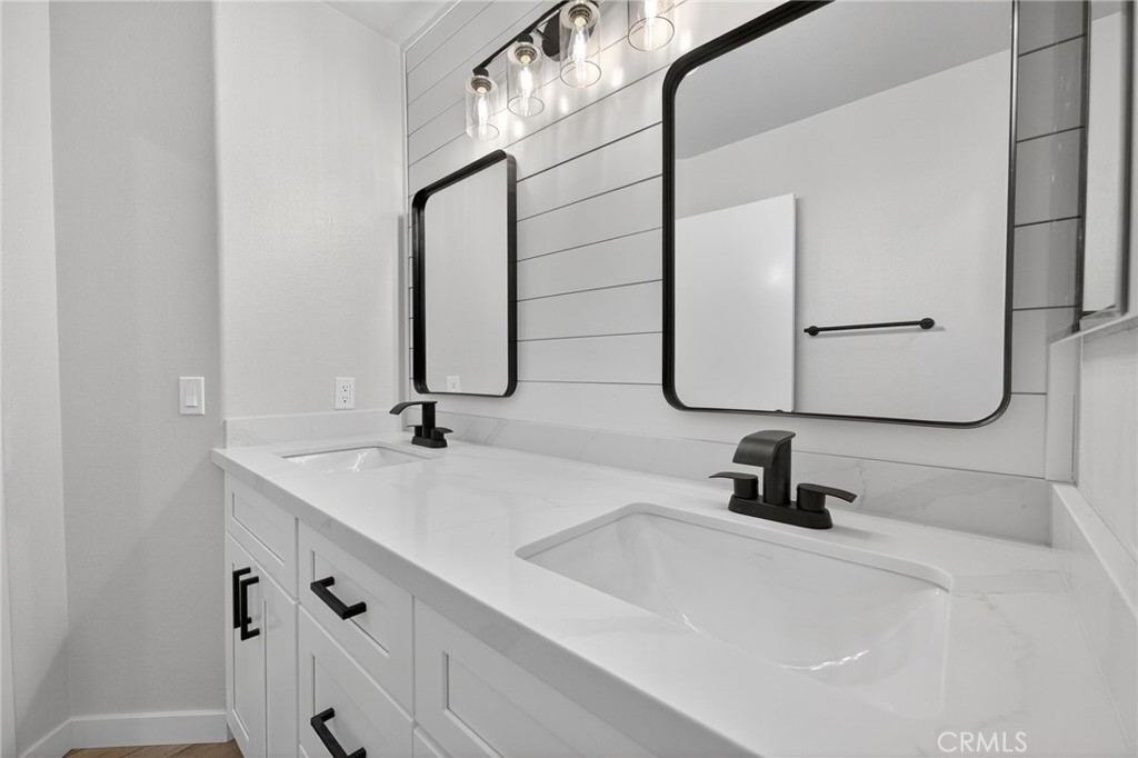 44797 Corte Sanchez Temecula, CA 92592 - Photo 26 of 58 a bathroom with double vanity sinks and a mirror