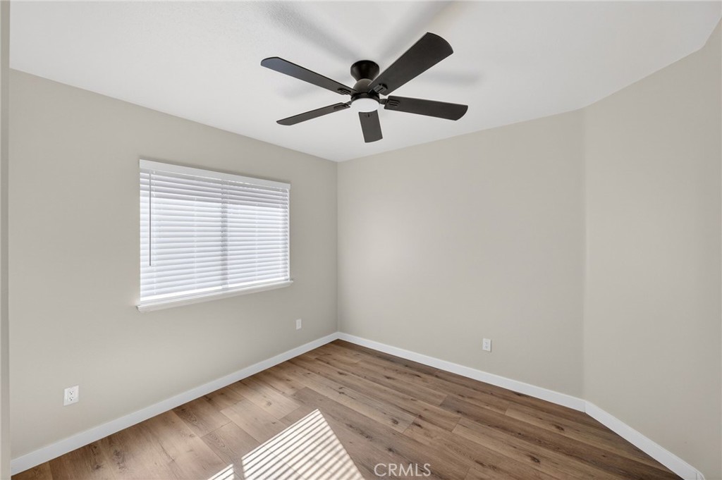 44797 Corte Sanchez Temecula, CA 92592 - Photo 27 of 58 a view of an empty room with wooden floor and a window