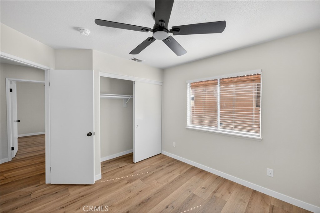 44797 Corte Sanchez Temecula, CA 92592 - Photo 28 of 58 a view of an empty room with wooden floor and a ceiling fan