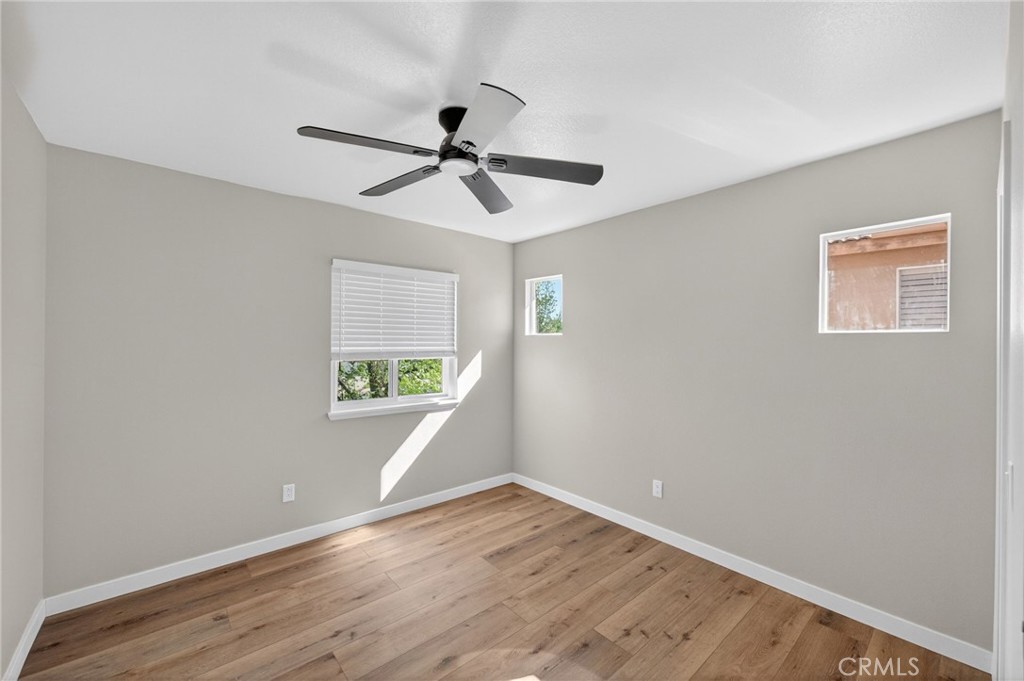 44797 Corte Sanchez Temecula, CA 92592 - Photo 30 of 58 a view of empty room with wooden floor and fan