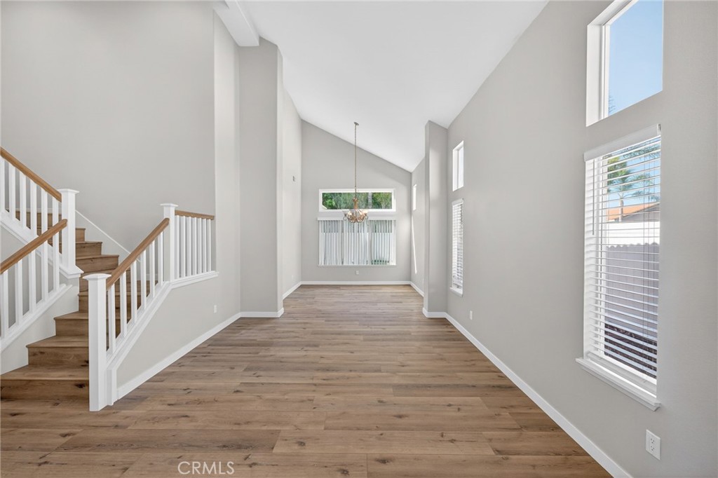 44797 Corte Sanchez Temecula, CA 92592 - Photo 3 of 58 a view of a hallway with wooden floor and windows