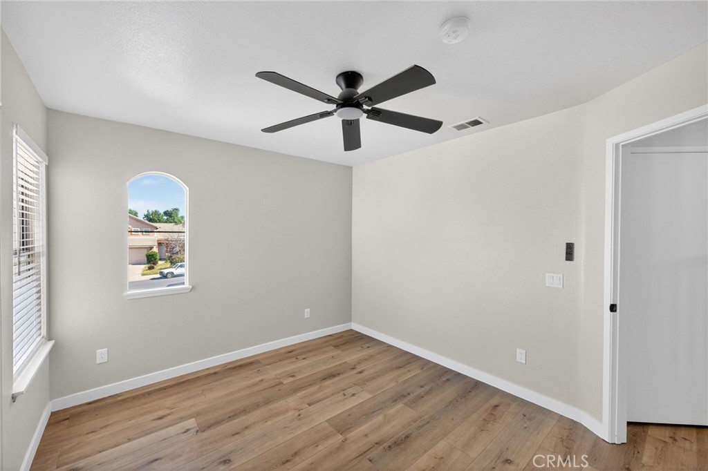 44797 Corte Sanchez Temecula, CA 92592 - Photo 33 of 58 a view of empty room with wooden floor and ceiling fan