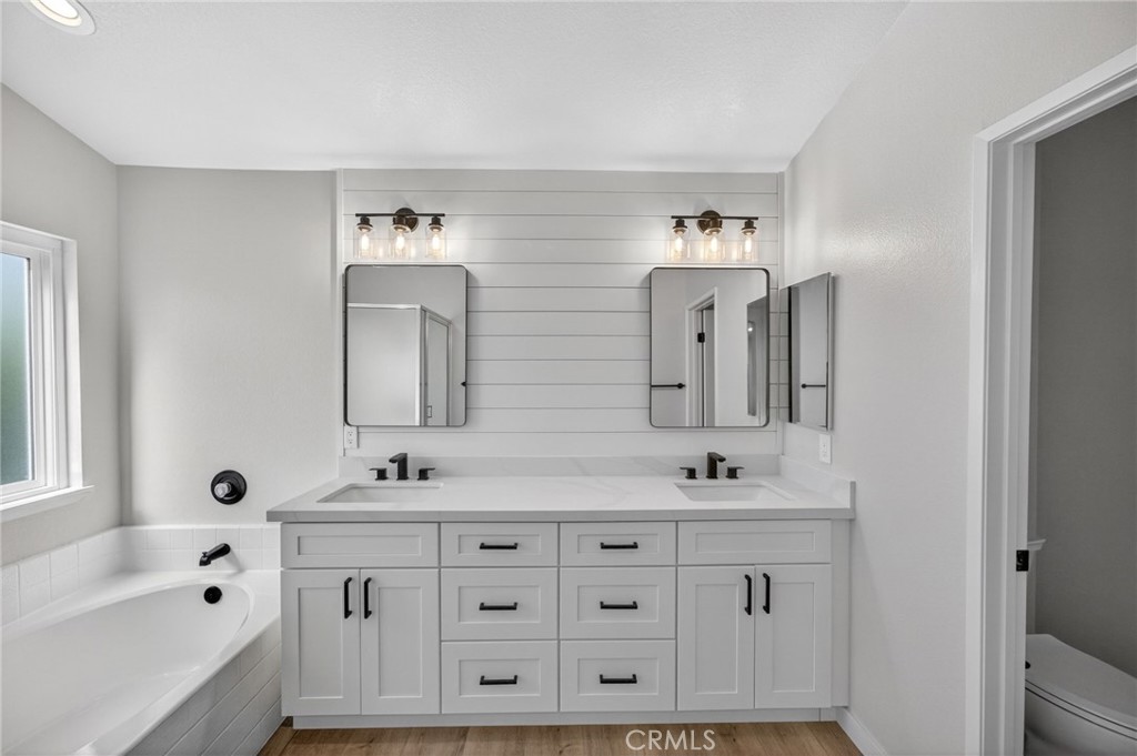 44797 Corte Sanchez Temecula, CA 92592 - Photo 38 of 58 a bathroom with a double vanity sink mirror double and bathtub