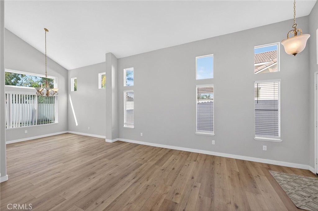 44797 Corte Sanchez Temecula, CA 92592 - Photo 4 of 58 an empty room with wooden floor and windows