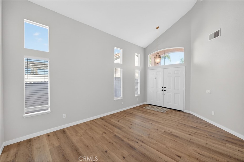 44797 Corte Sanchez Temecula, CA 92592 - Photo 5 of 58 a view of an empty room with wooden floor and a window