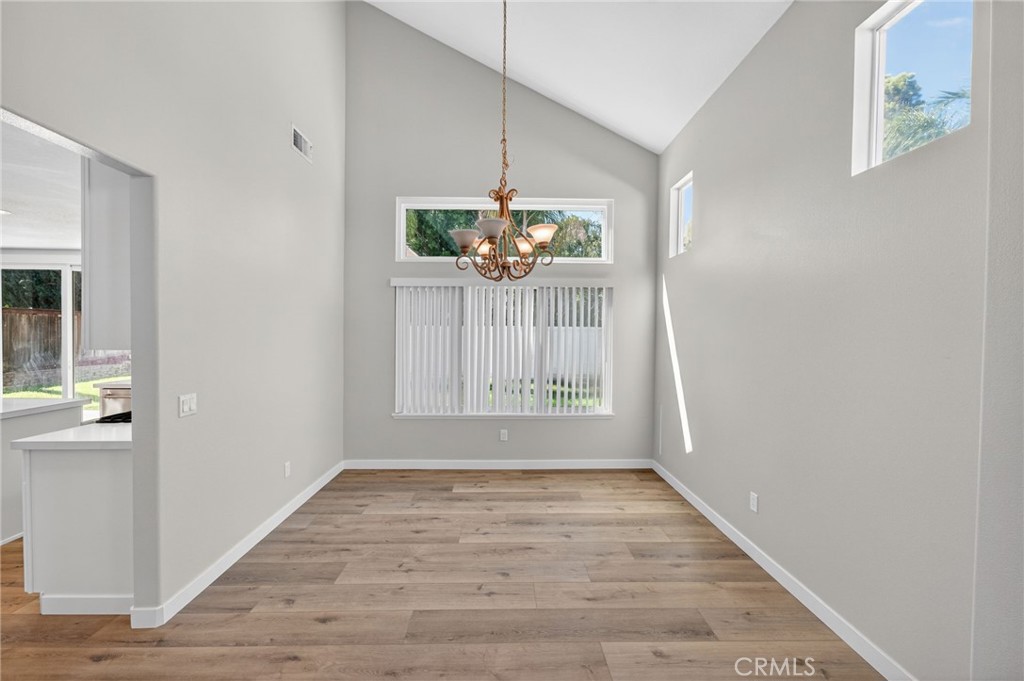 44797 Corte Sanchez Temecula, CA 92592 - Photo 9 of 58 a view of an empty room with window and wooden floor