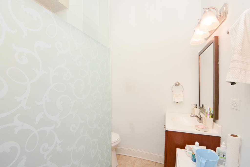 2347 West 24th Place, Unit 1R Chicago, IL 60608 - Photo 20 of 21 a bathroom with a sink and a mirror