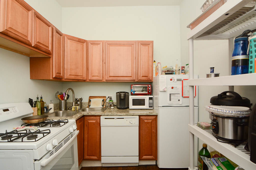 2347 West 24th Place, Unit 1R Chicago, IL 60608 - Photo 3 of 21 a kitchen with a stove and a refrigerator