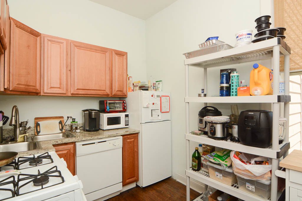 2347 West 24th Place, Unit 1R Chicago, IL 60608 - Photo 4 of 21 a kitchen with stainless steel appliances granite countertop a stove and white cabinets