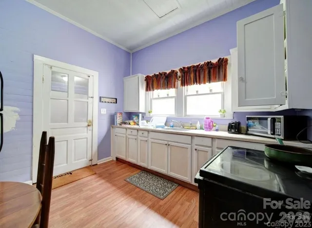 a kitchen with a sink stove and cabinets