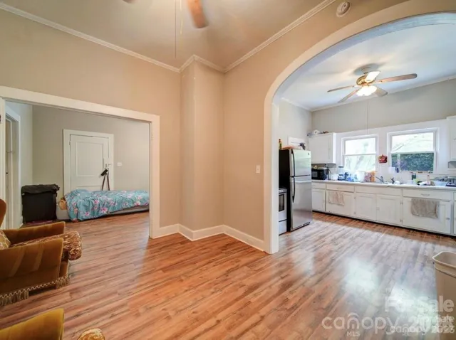 a view of a kitchen and kitchen with wooden floor