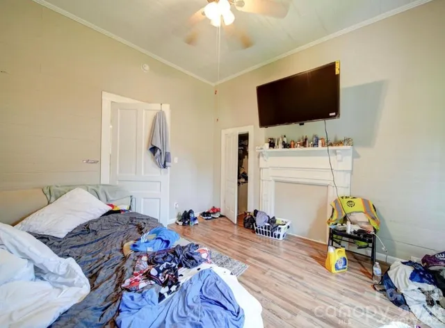 a bed room with a bed a television and a mirror