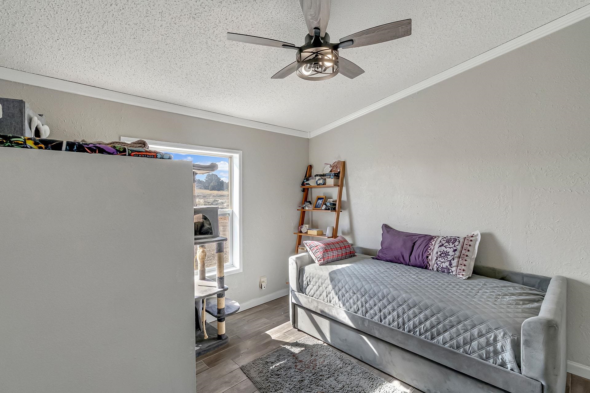 13090 Bs Road Glade Park, CO 81523 - Photo 12 of 40 a bedroom with a bed and a window