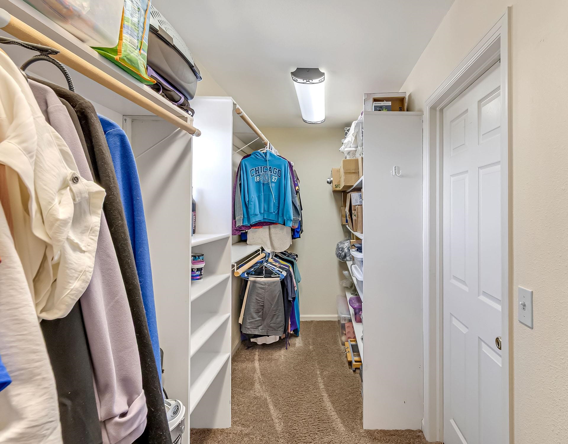 13090 Bs Road Glade Park, CO 81523 - Photo 29 of 40 a view of walk in closet with clothes and shoes