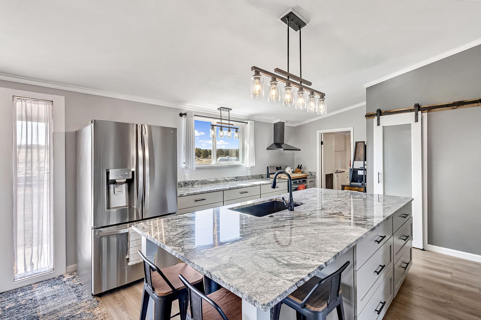 13090 Bs Road Glade Park, CO 81523 - Photo 6 of 40 a kitchen with stainless steel appliances granite countertop center island and refrigerator