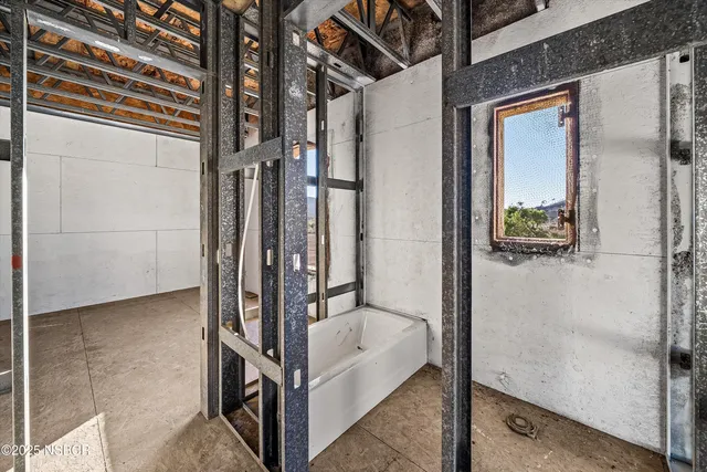 a view of an empty room with kitchen