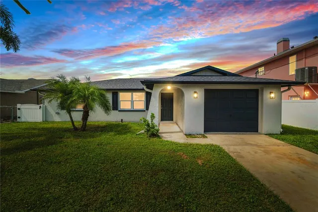 a front view of a house with a garden and yard