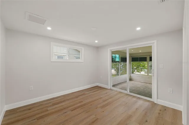 a view of wooden floor and windows in a room