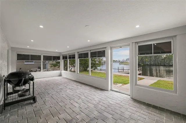 a room with a large window and furniture