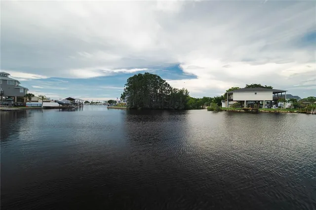 a view of a street with a big yard and a fountain