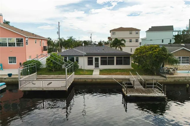 an aerial view of residential houses with outdoor space and parking