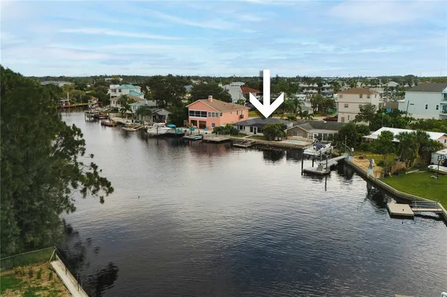 an aerial view of a house with a lake view