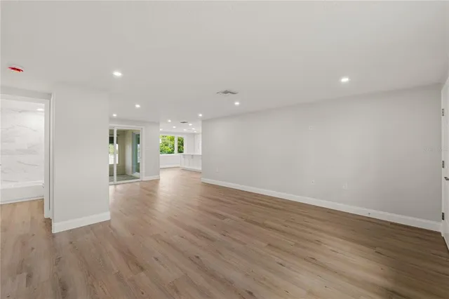a view of an empty room with wooden floor