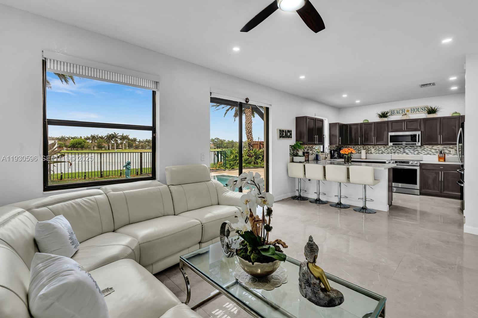 11709 Southwest 253rd Street Homestead, FL 33032 - Photo 15 of 47 a living room with furniture and a large window
