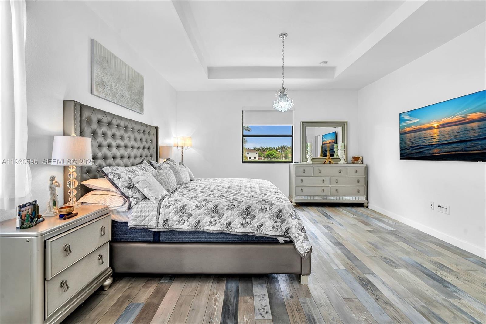 11709 Southwest 253rd Street Homestead, FL 33032 - Photo 20 of 47 a spacious bedroom with a large bed and a flat tv screen on dresser