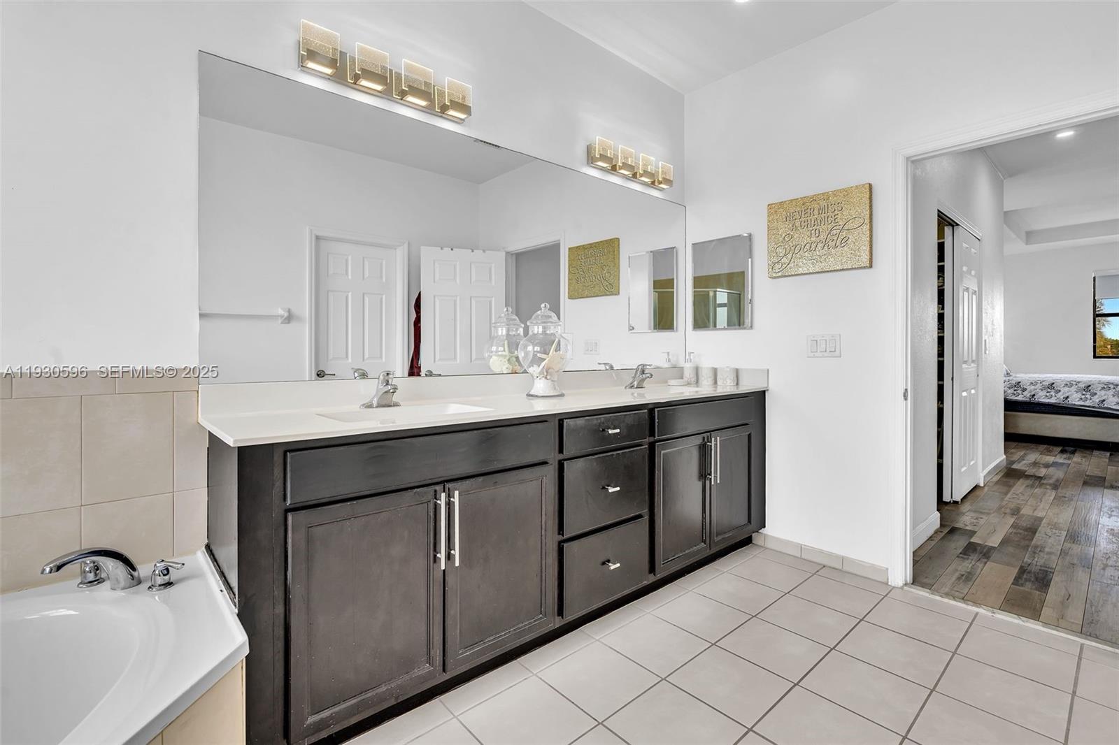 11709 Southwest 253rd Street Homestead, FL 33032 - Photo 21 of 47 a bathroom with a sink vanity and mirror