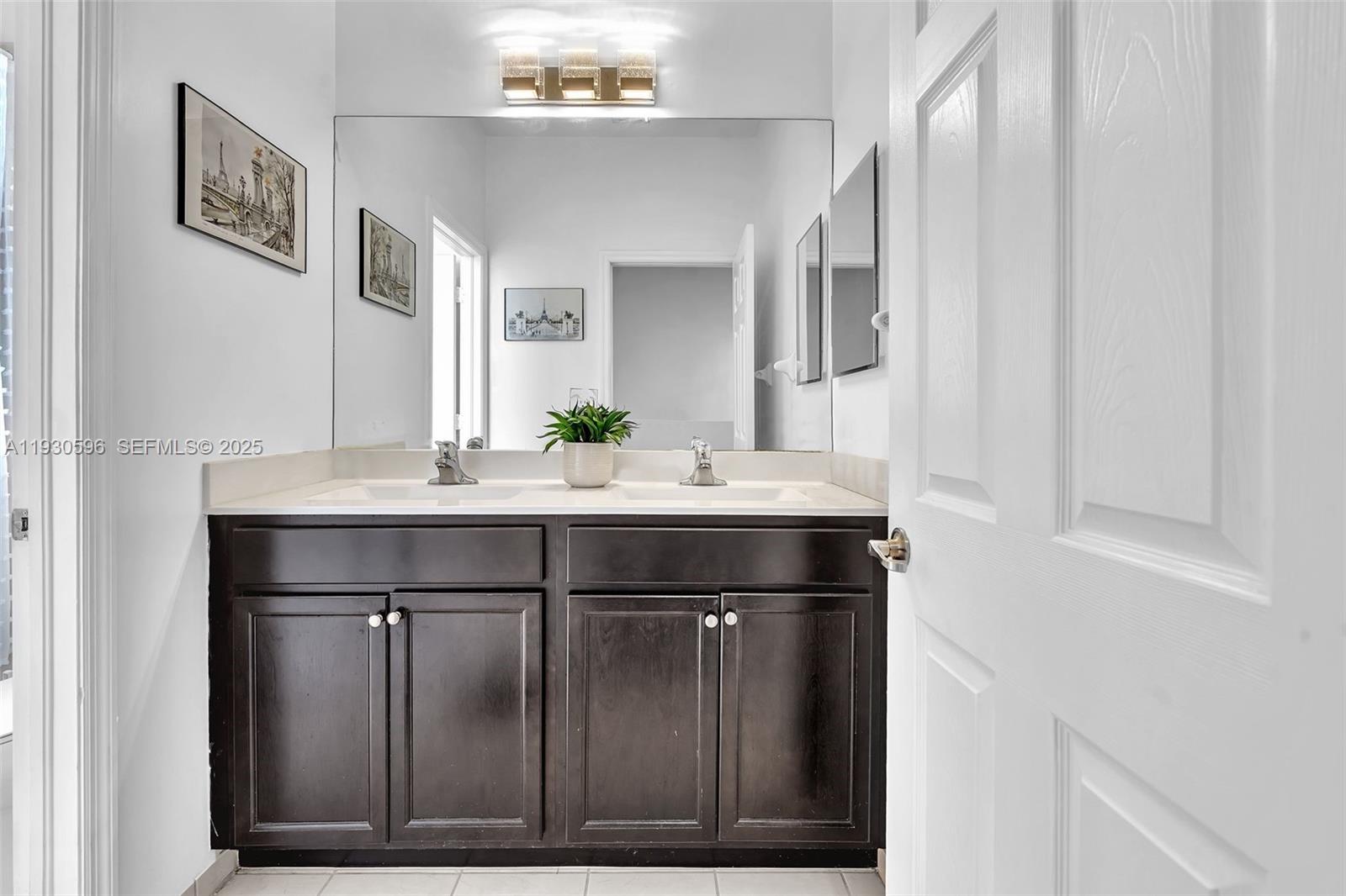 11709 Southwest 253rd Street Homestead, FL 33032 - Photo 23 of 47 a bathroom with a sink vanity and a mirror