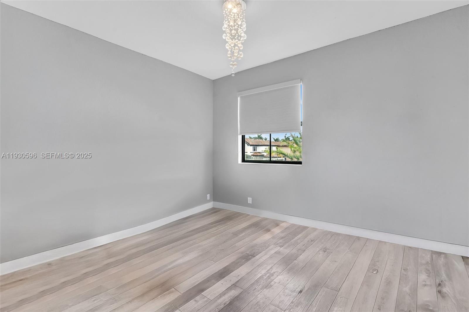 11709 Southwest 253rd Street Homestead, FL 33032 - Photo 24 of 47 wooden floor in an empty room with a window