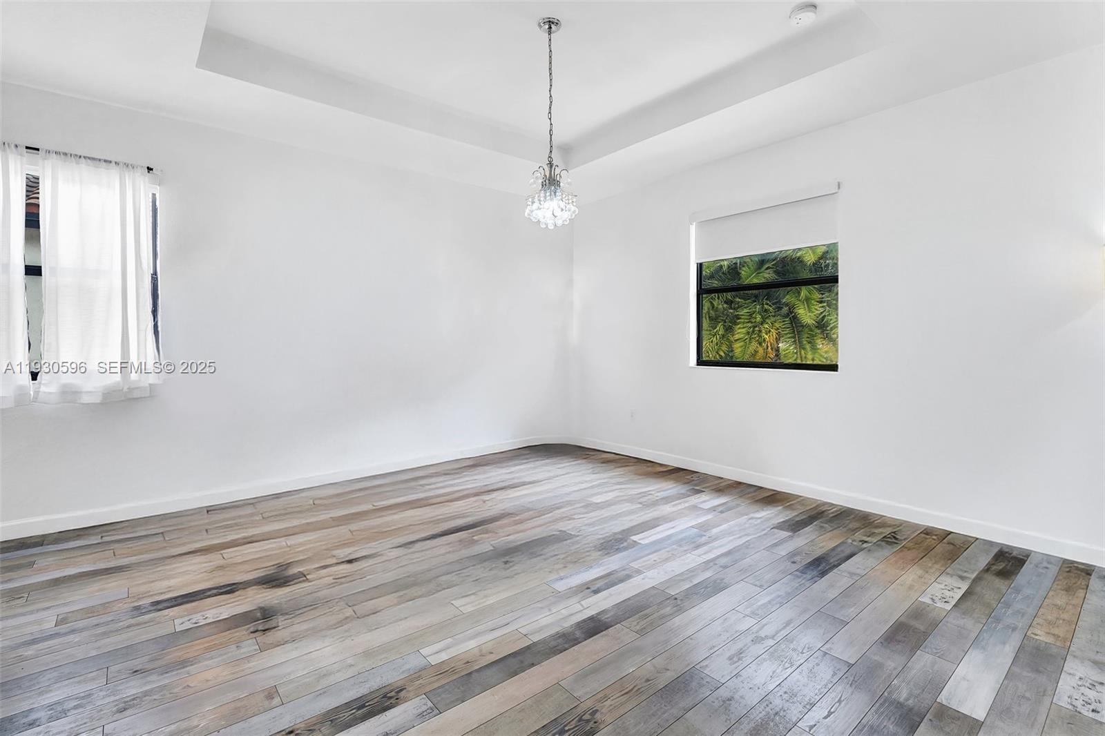 11709 Southwest 253rd Street Homestead, FL 33032 - Photo 25 of 47 an empty room with wooden floor and windows