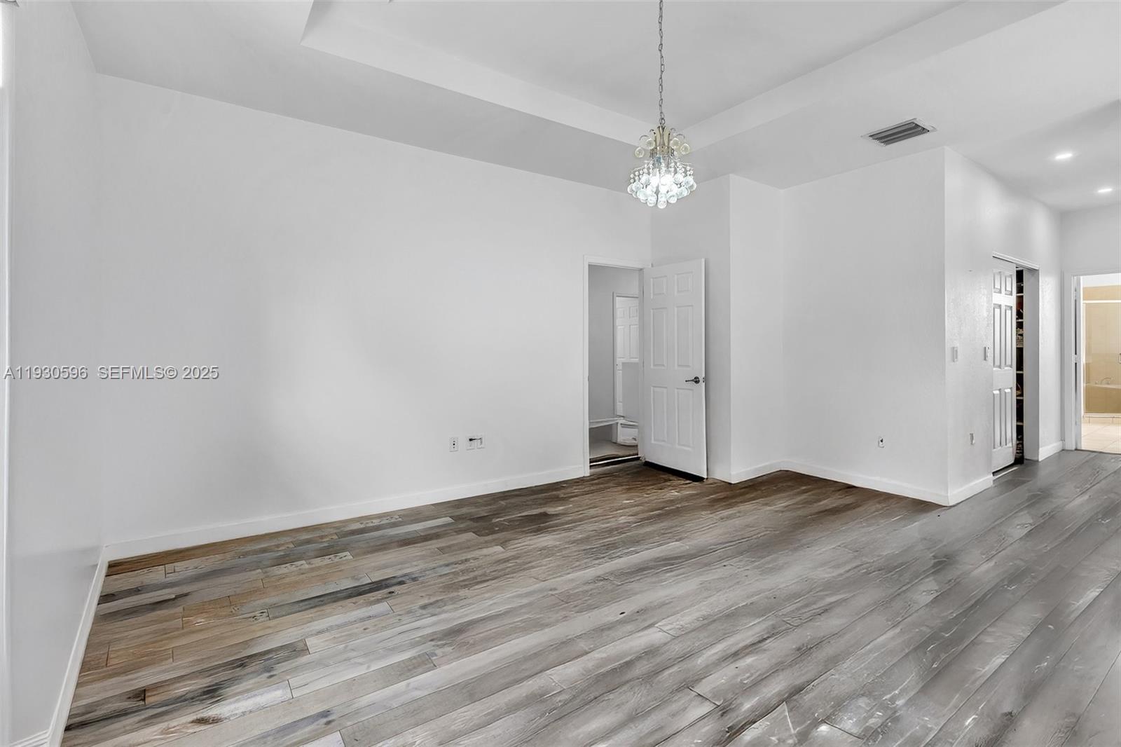 11709 Southwest 253rd Street Homestead, FL 33032 - Photo 26 of 47 an empty room with wooden floor and ceiling fan
