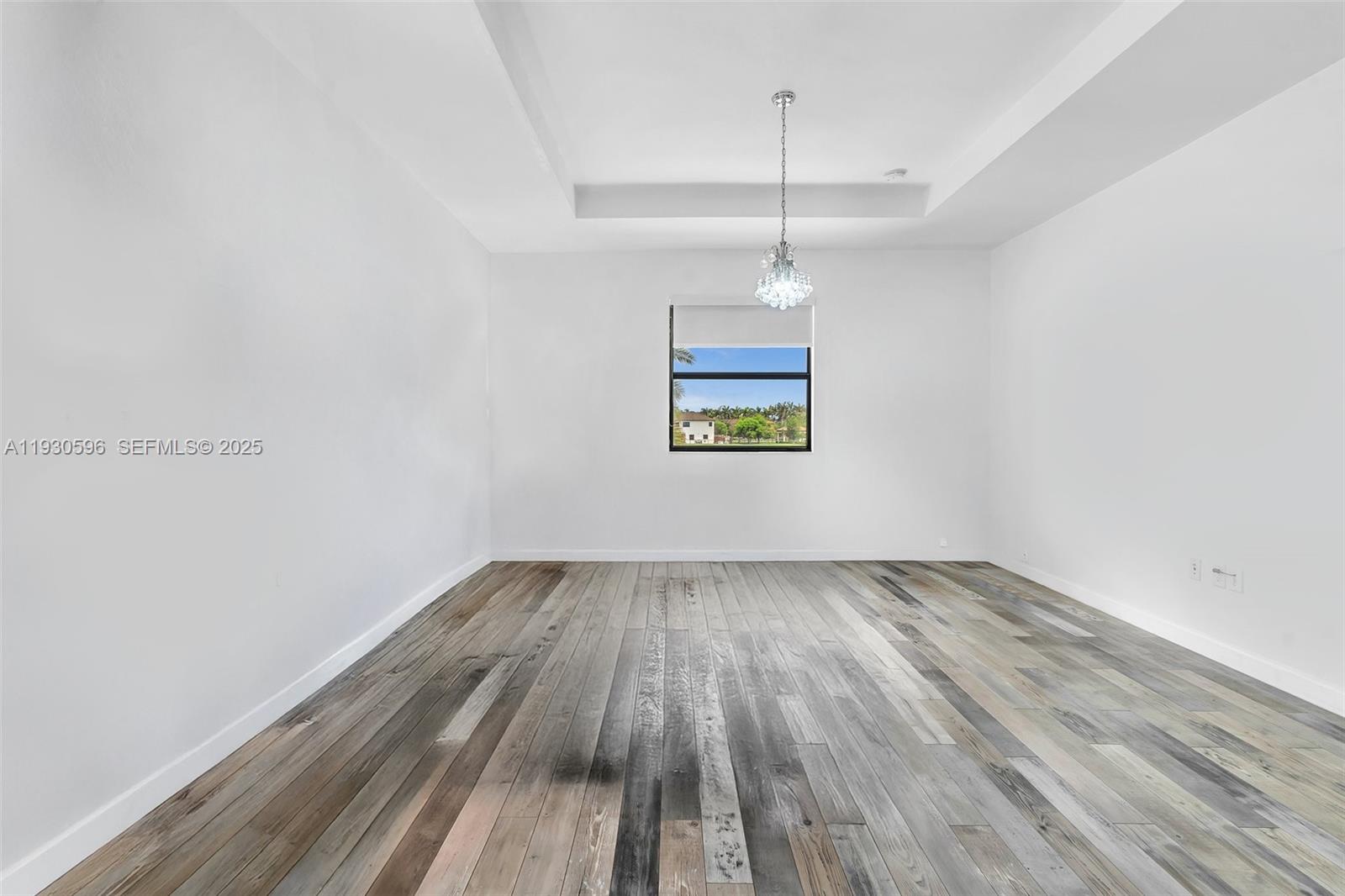11709 Southwest 253rd Street Homestead, FL 33032 - Photo 27 of 47 a view of an empty room with wooden floor and a window