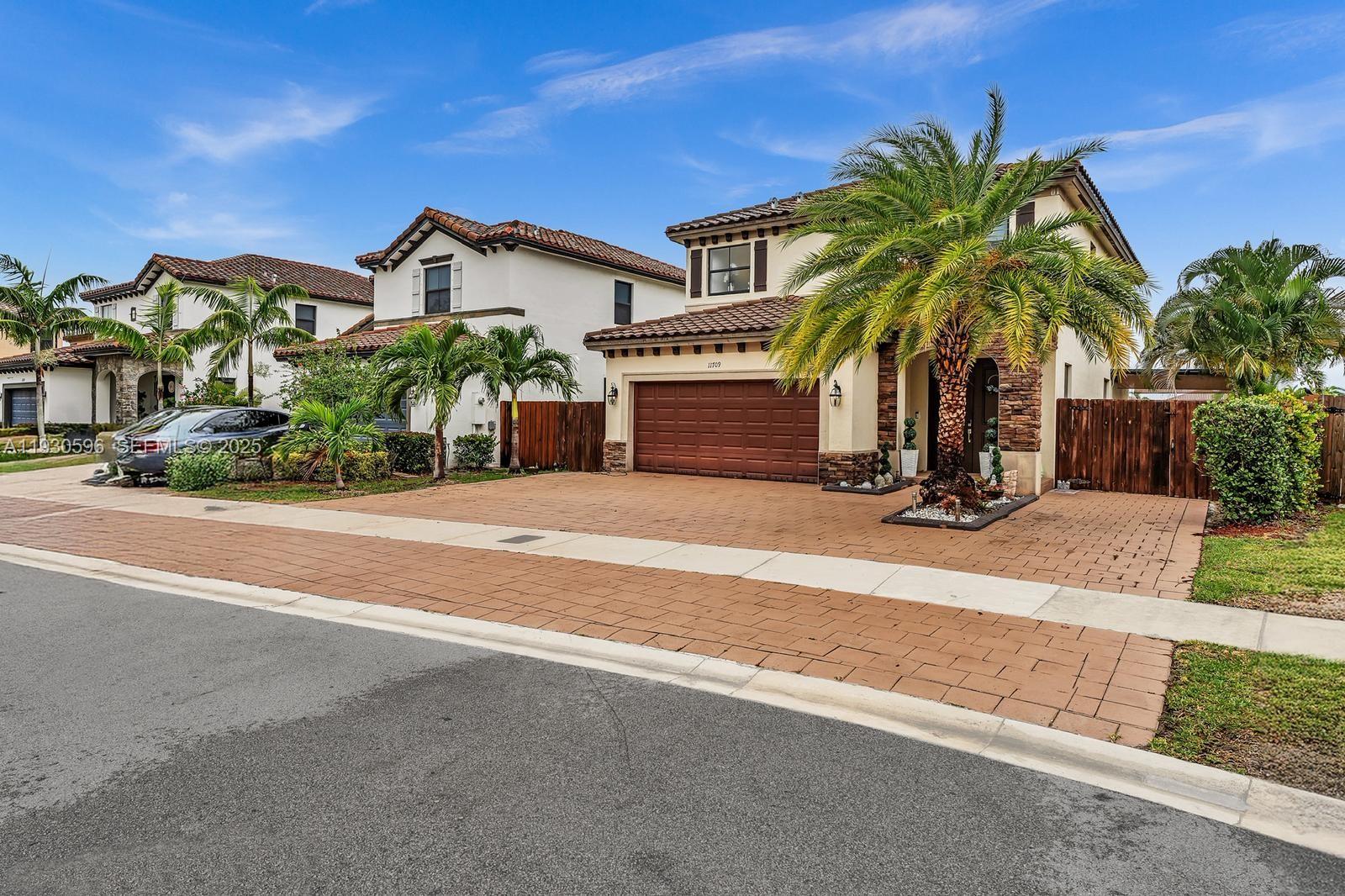 11709 Southwest 253rd Street Homestead, FL 33032 - Photo 3 of 47 front view of house with palm trees