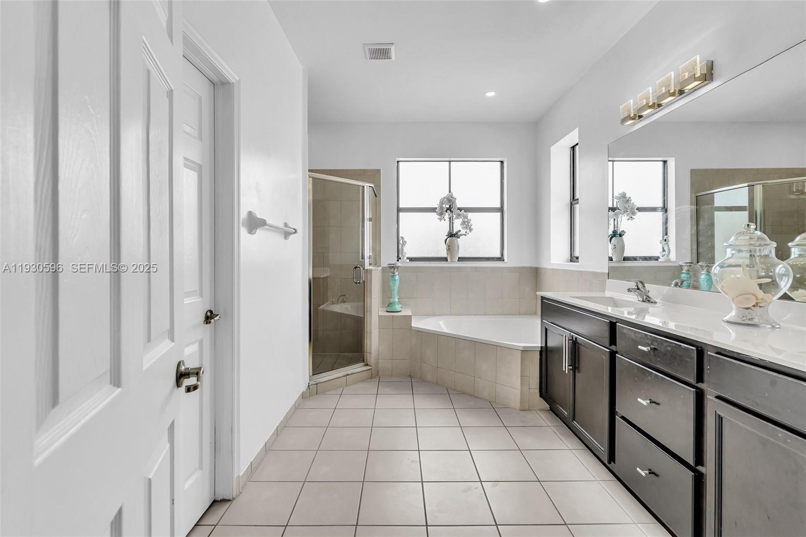 11709 Southwest 253rd Street Homestead, FL 33032 - Photo 33 of 47 a bathroom with a sink a mirror and a bathtub