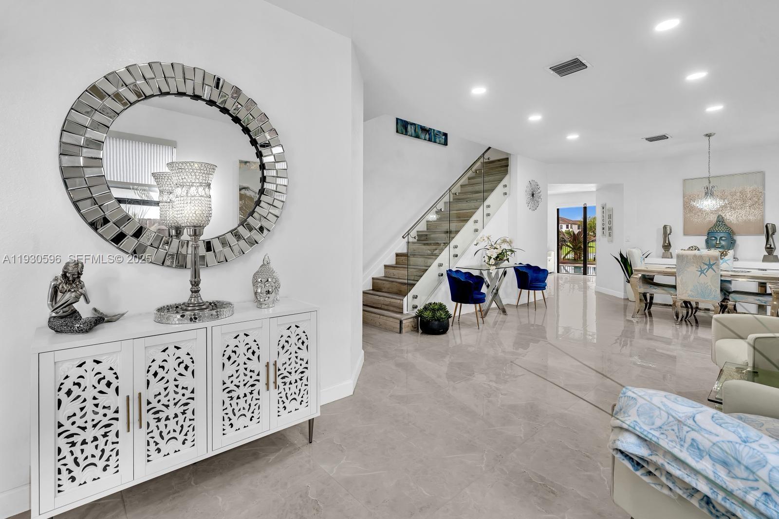 11709 Southwest 253rd Street Homestead, FL 33032 - Photo 7 of 47 a living room with furniture and a chandelier