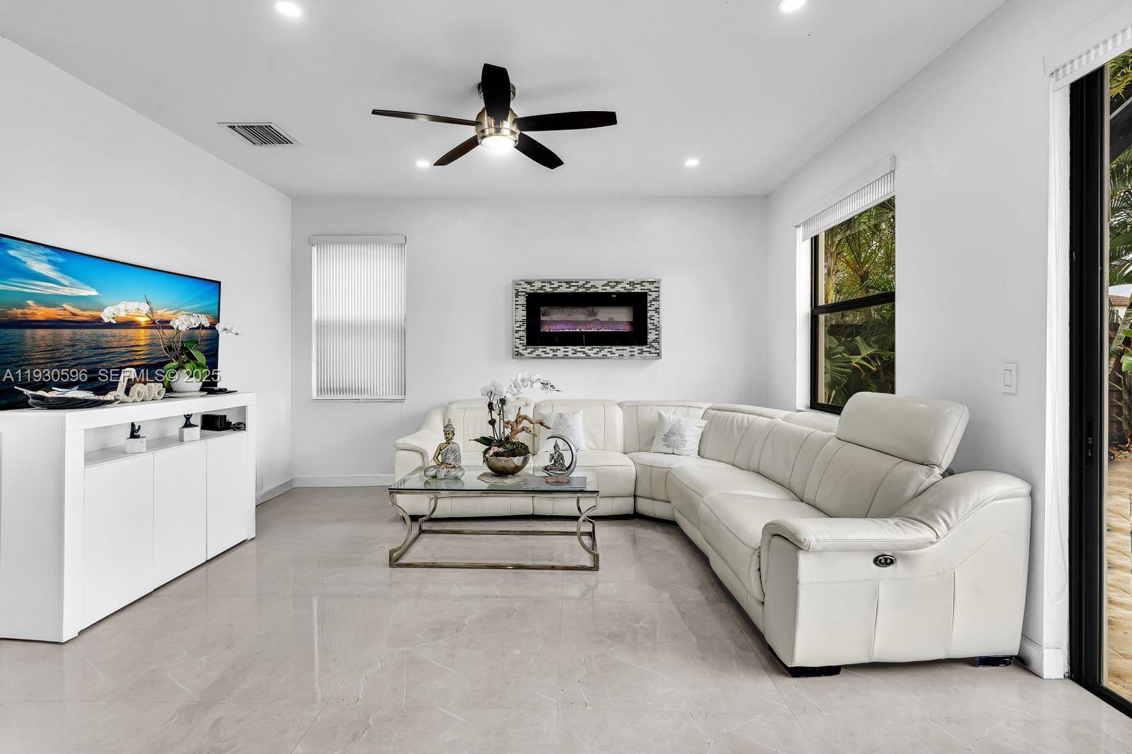 11709 Southwest 253rd Street Homestead, FL 33032 - Photo 10 of 47 a living room with furniture and a flat screen tv