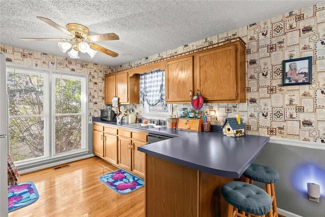 a kitchen filled with a large window appliances and furniture