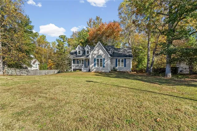 a house with swimming pool in front of it