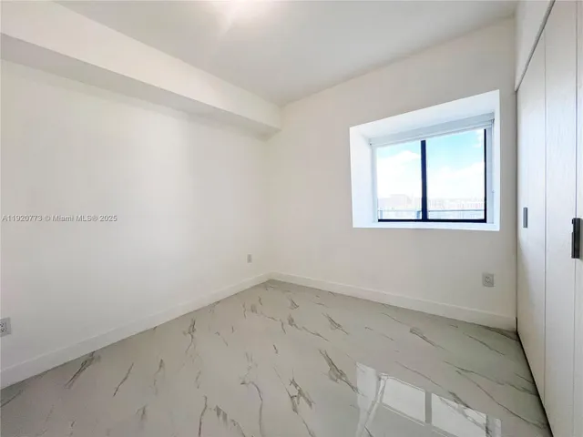 a living room with furniture and potted plants