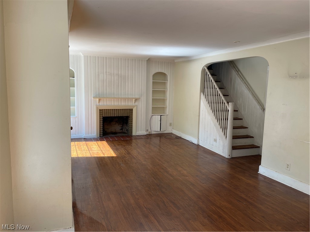 1730 Wood Road Cleveland Heights, OH 44121 - Photo 6 of 34 Hardwood floored living room with built in shelves and a fireplace