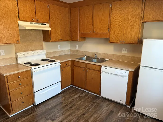 a view of a kitchen with sink and cabinets
