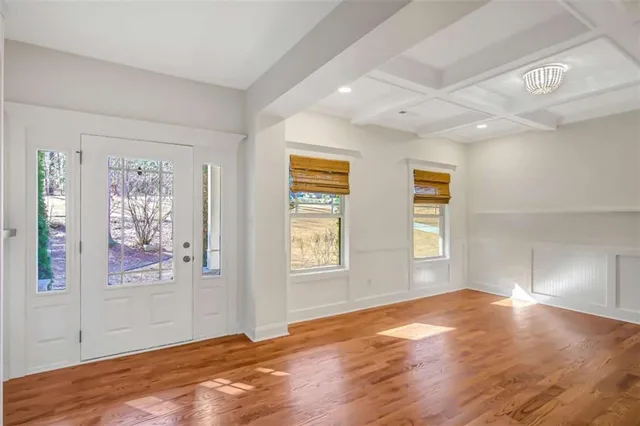 a kitchen with a stove and a wooden floor