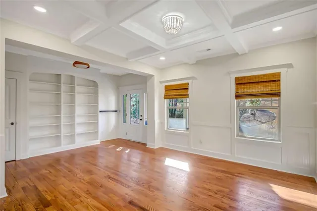 a kitchen with a stove a sink a center island and wooden floor